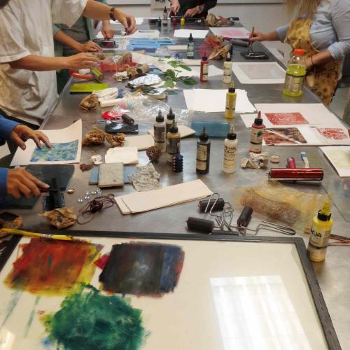 the studio work table with inks and tools shared by the class