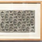 black and white striped triangles in a horizontal grid, seen through a top layer of light gray. Vibrating Triangles (Gray on Black) by Bill Brookover